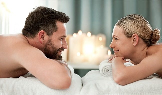 Man and woman drinking champagne after bath